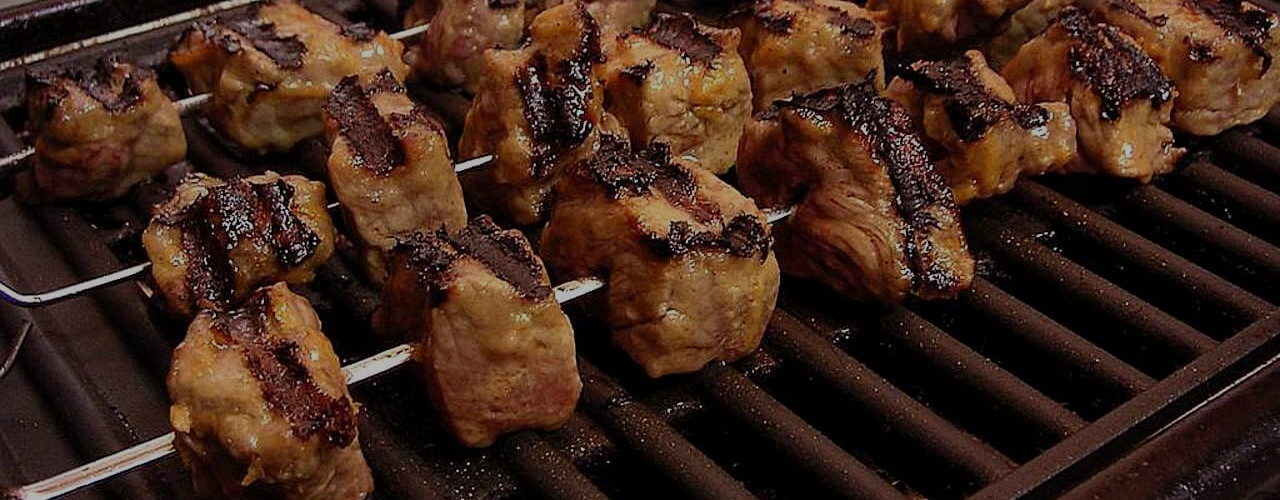 BBQ catering with grilled steaks and outdoor setup